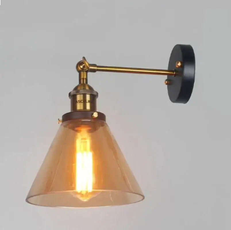 Industrial vintage brass wall sconce with amber glass shade and black mounting plate for bedroom decorbites lighting
