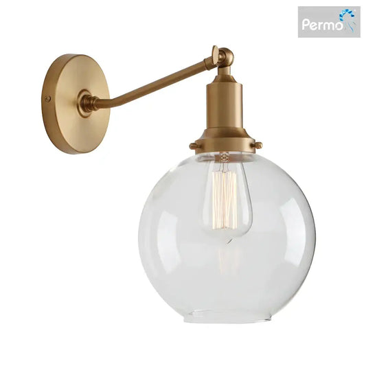 Brass-finished industrial vintage wall sconce with clear glass globe and exposed filament bulb for bedroom decorbites decor