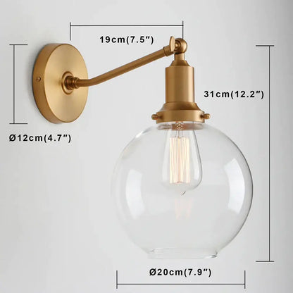 Brass-finished industrial vintage wall sconce with clear glass globe and exposed filament bulb for bedroom decorbites lighting