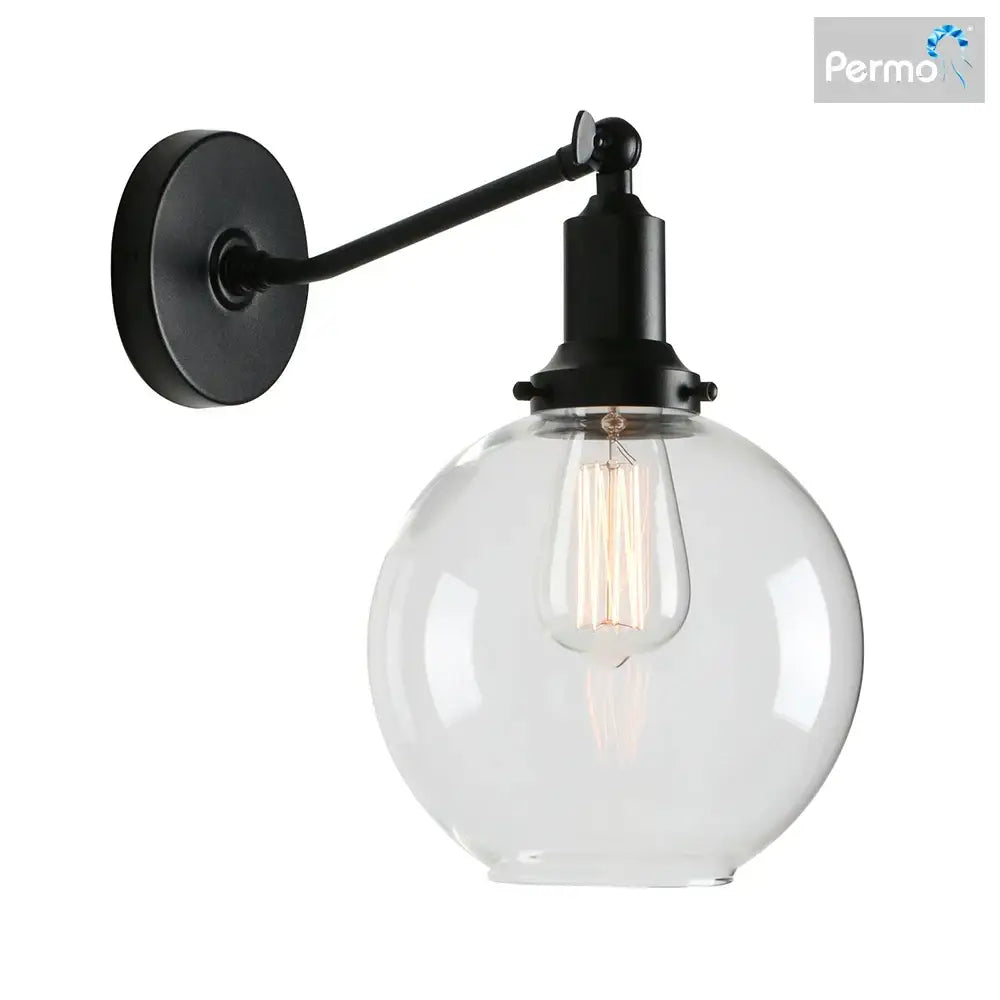 Black metal wall sconce with clear glass globe and exposed filament bulb in decorbites industrial vintage style