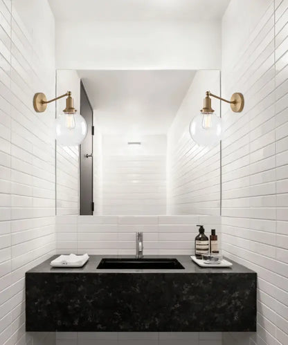 Black marble sink with sleek rectangular design and modern chrome faucet complement decorbites industrial vintage wall sconce