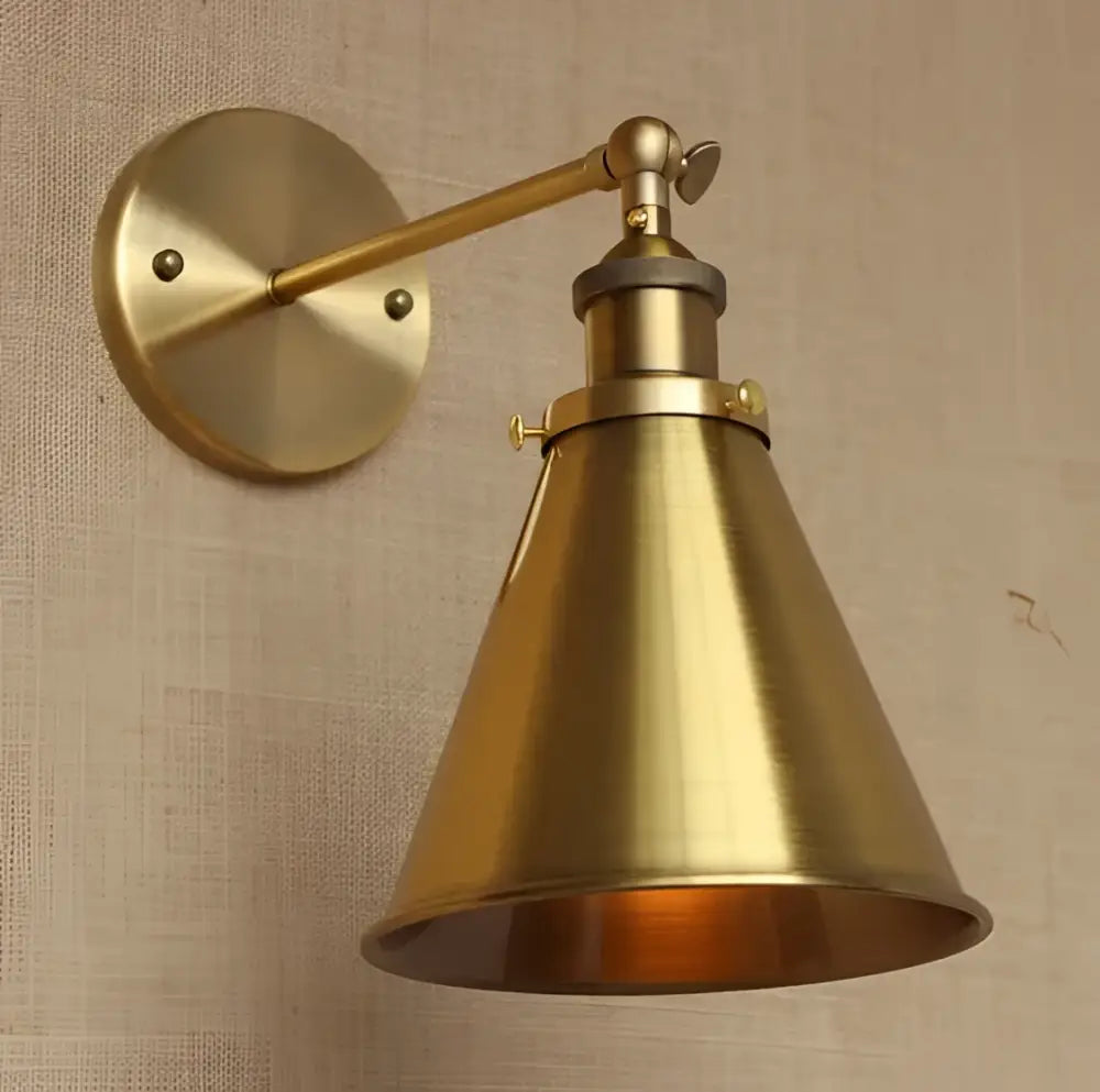 Brass-finished industrial vintage wall sconce with adjustable arm and conical shade for bedroom decorbites lighting