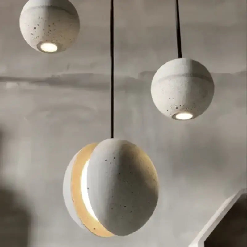 Concrete sphere pendant lamp with speckled texture and warm light industrial vintage cement decorbites style for kitchen dining room