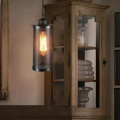 Industrial vintage metal pendant light with black mesh cage and exposed edison bulb for kitchen lighting