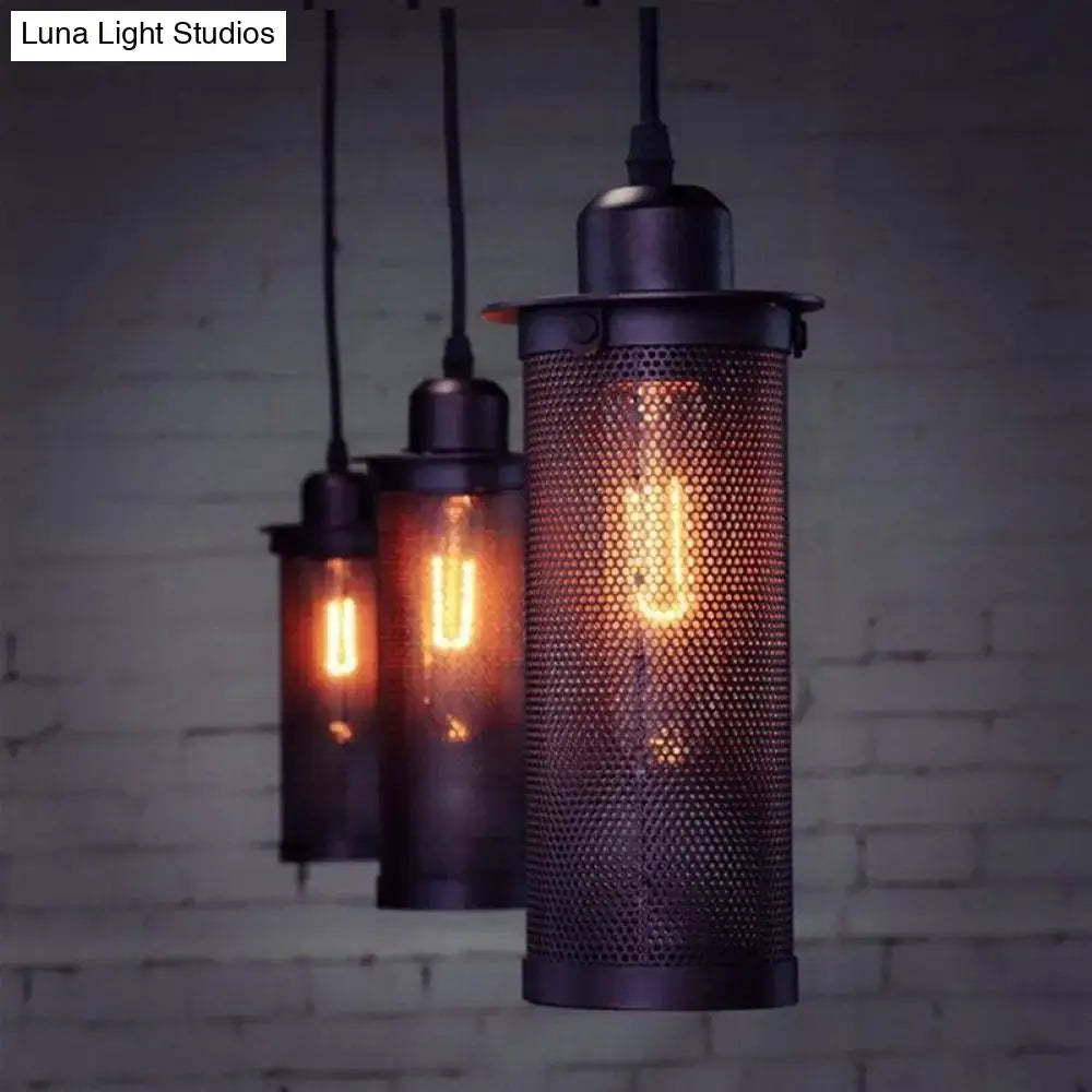 Industrial vintage metal pendant light with dark metal mesh cylinder and exposed filament bulb for kitchen use