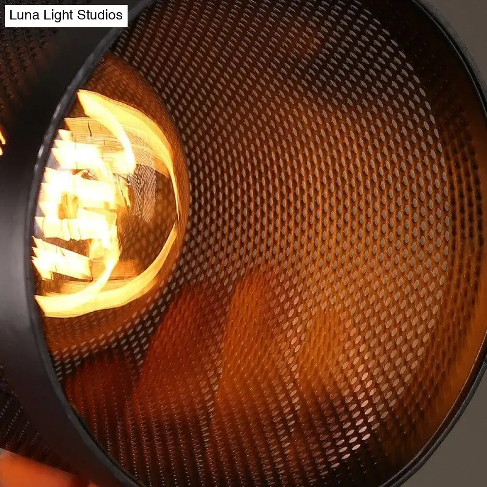 Industrial vintage metal pendant light with black perforated mesh cage and warm amber glow pendant light