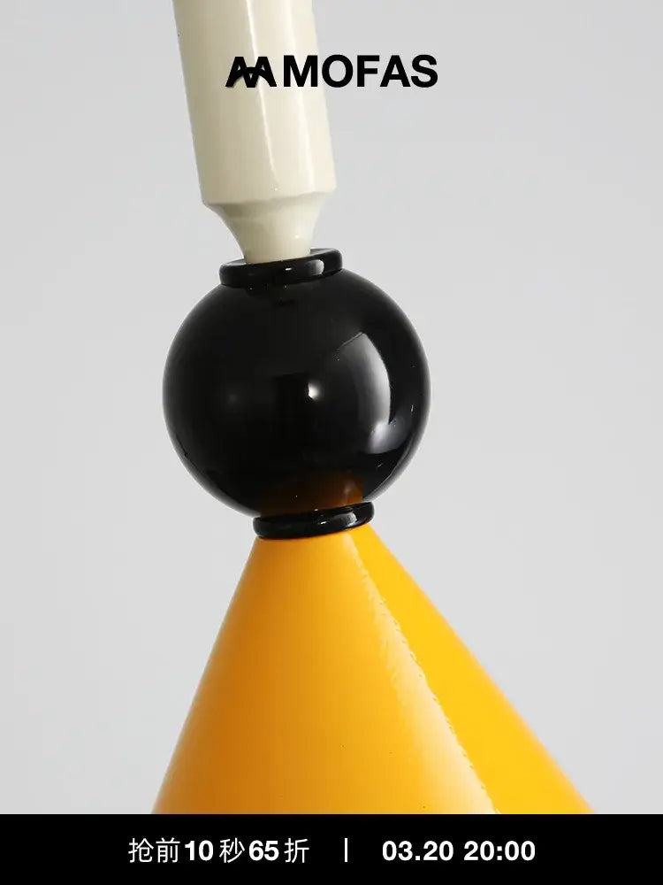 A sleek industrial vintage pendant light with a glossy black middle, cream top, and yellow conical base decorbites pendant light