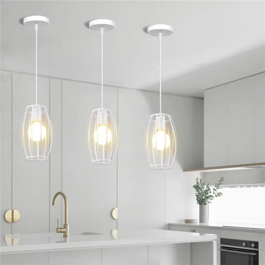 Three modern white wrought cage pendant lights with clear glass hang above a kitchen island decorbites industrial vintage