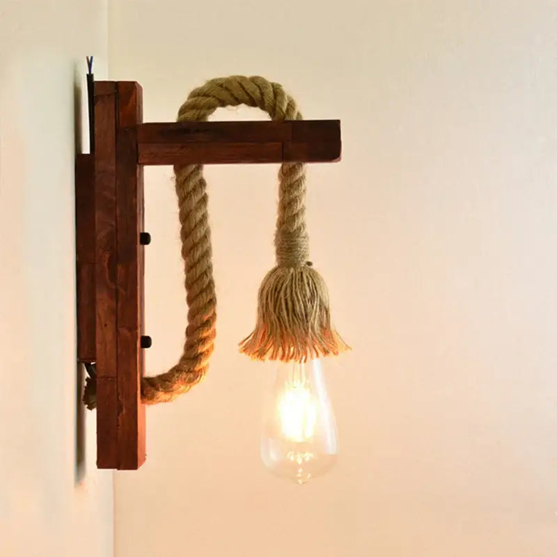 Rustic wooden wall lamp with beige rope and frayed tassel featuring exposed Edison bulb decorbites industrial vintage decor