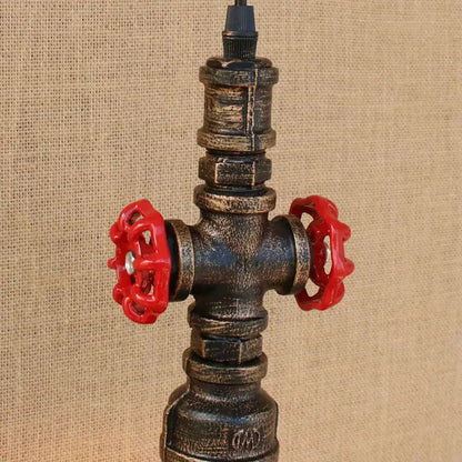 Industrial water pipe pendant light with dark weathered metal body and bright red valve handles for dining room decorbites industrial water