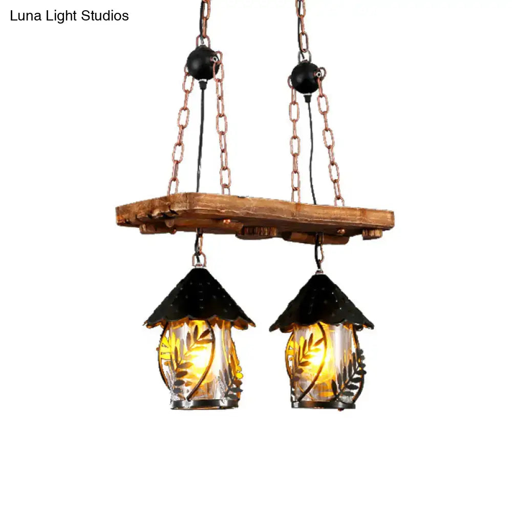 Rustic industrial white clear wood lantern island lighting features black-topped glass lanterns with leaf etchings and warm light