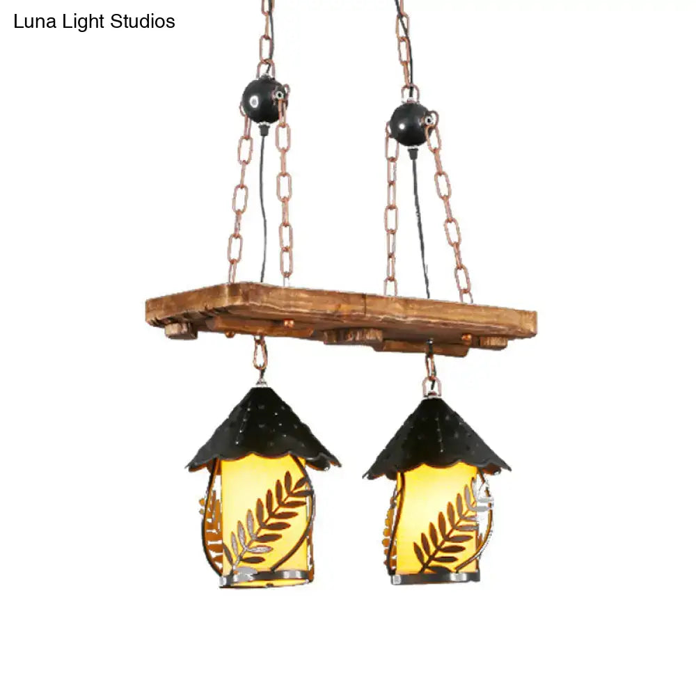 Rustic wooden plank with industrial white clear lantern island lighting featuring black roof and amber etched glass panels