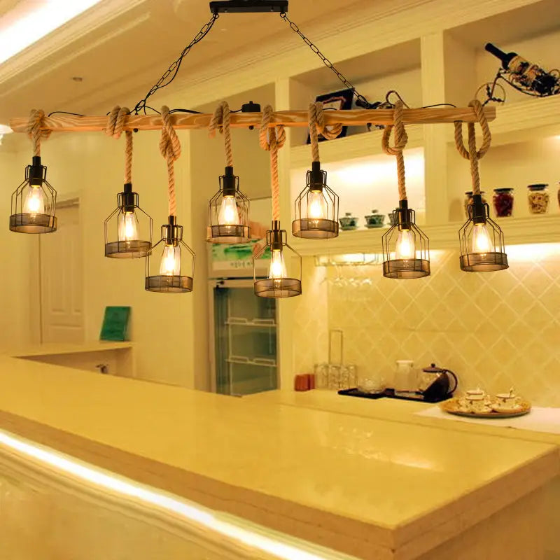 Industrial-style decorbites™ hang-it-out farmhouse pendant lamp with wooden beam, thick rope, and metal cage lanterns housing warm bulbs