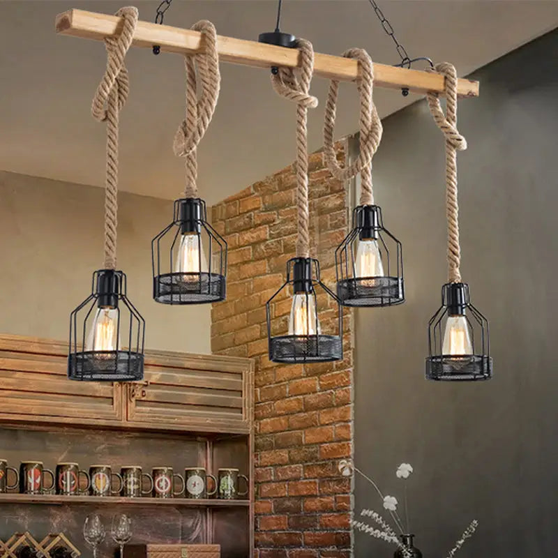 DecorBites™ hang-it-out farmhouse pendant lamp with wooden beam, beige rope suspensions, and five black metal cage lanterns