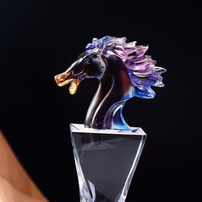 Iridescent decorbites crystal horse trophy with blue to purple mane and golden accents on clear crystal base