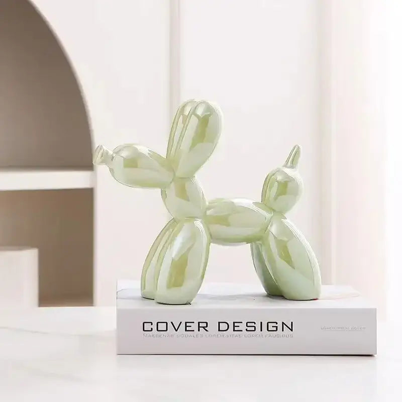 A glossy mint-green ceramic sculpture balloon dog with an iridescent finish for modern living room decor