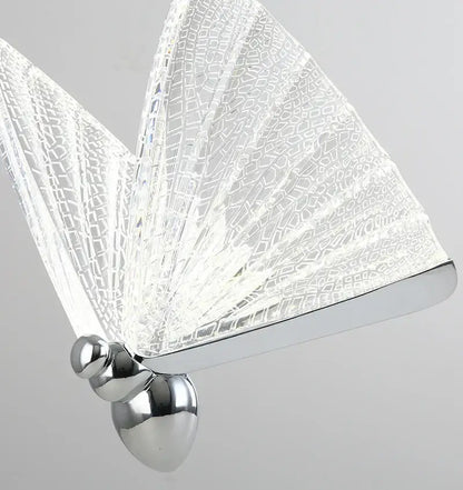 A modern butterfly pendant light with iridescent gold crackled glass wings and polished chrome base for decorbites butterfly decor