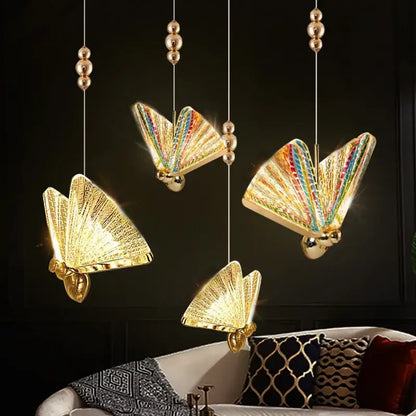 Iridescent gold butterfly pendant lights with rainbow wings and metallic accents for living and dining rooms