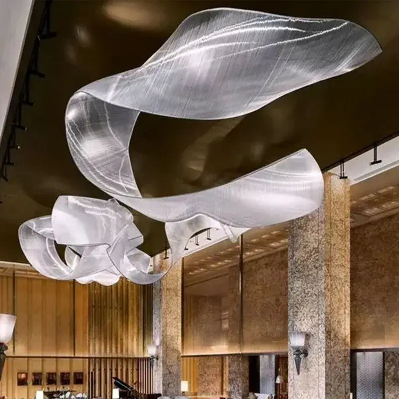 A sleek translucent silver chandelier pendant light with flowing ribbon-like curves for living room lighting