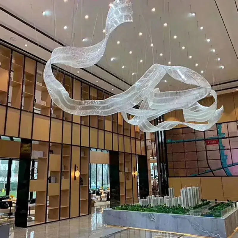 A translucent iridescent glass chandelier pendant light with a modern ribbon design for living room lighting