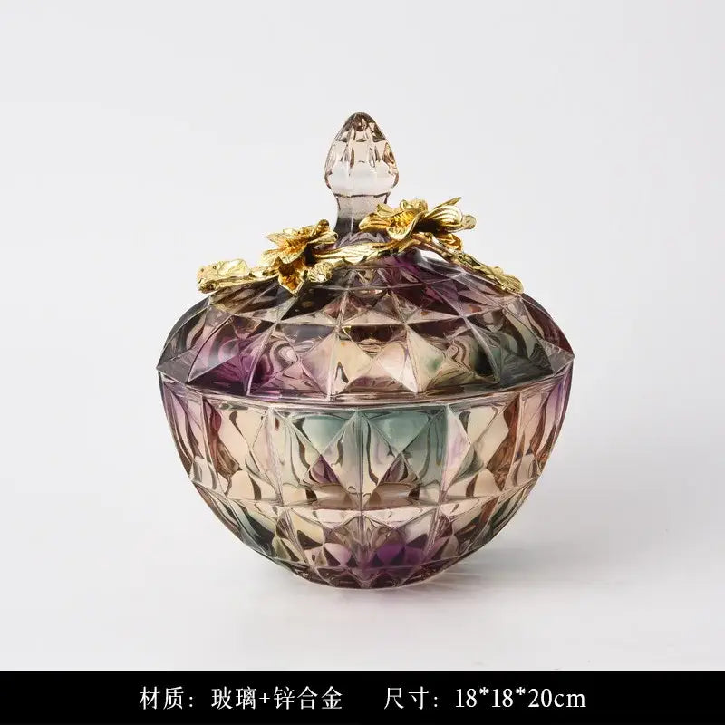 Iridescent faceted crystal glass candy jar with gold-toned metal lid and flower embellishments for elegant display