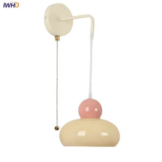 Cream and blush pink two-tiered decorbites iron nordic led wall light with curved white arm and brass pull chain for bedroom decor