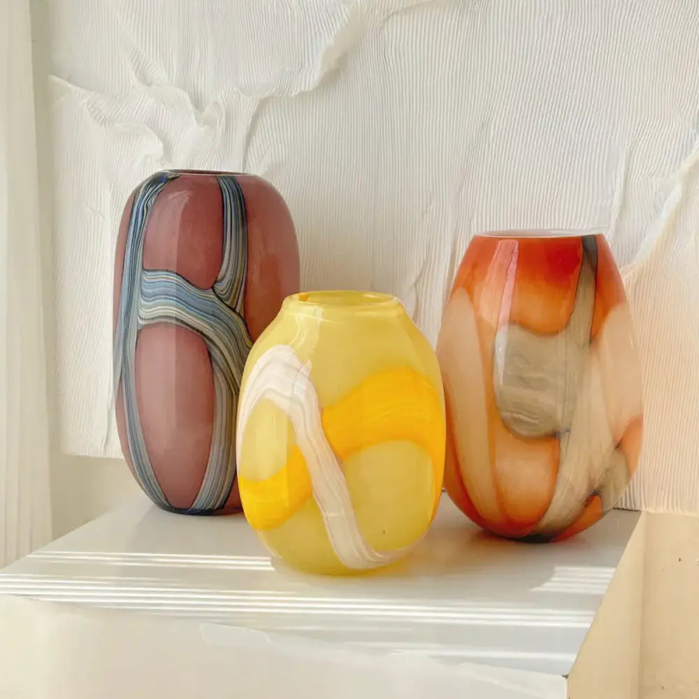 Three hand-blown glass vases with irregular geometric graffiti patterns in pink yellow orange and gray for decorbites decor