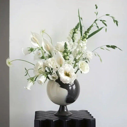 A sleek black and white ceramic irregular grain spherical vase with calla lilies for living room decorbites decor
