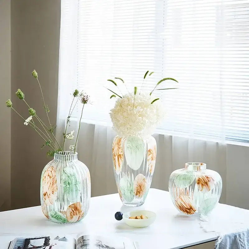 Three irregular ribbed green and brown clear glass vases with painted floral patterns holding dried flowers decorbites clear glass vase for living room decor