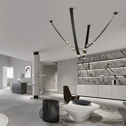 Black minimalist chandelier with sleek curved arms and spherical lights in decorbites italian light luxury leather design