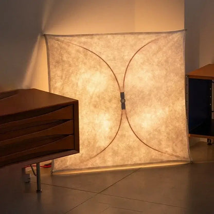 A warm glowing italian vintage ceiling light with beige fabric shade and curved black metal frame for living room decor