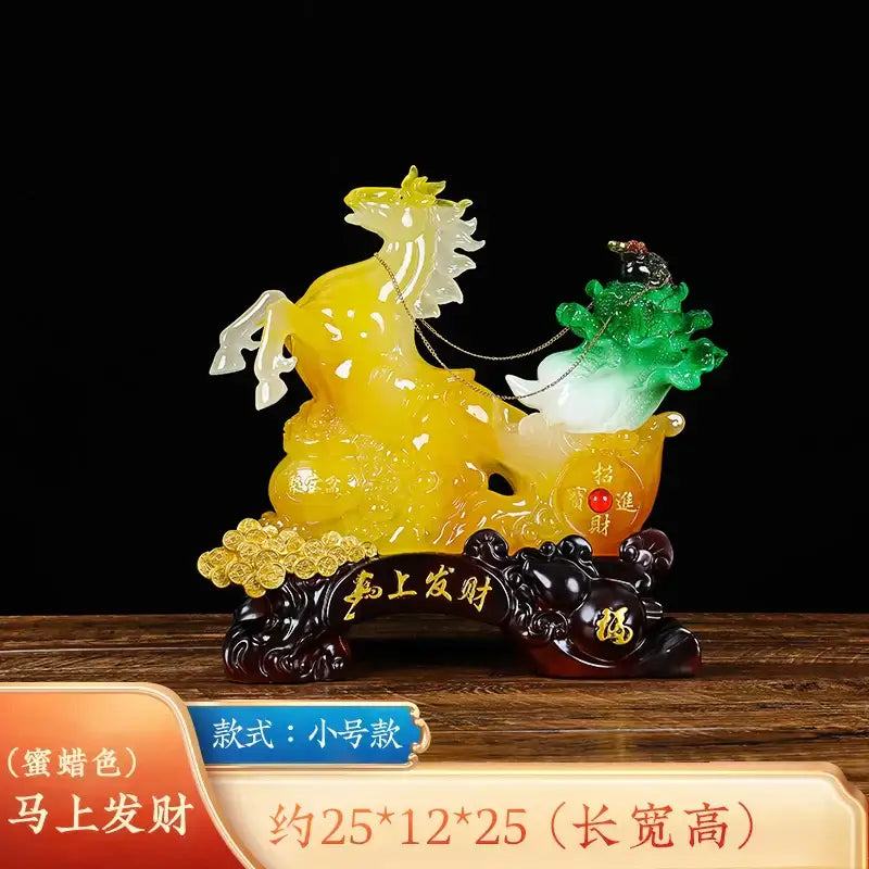 Translucent yellow and white jade fortune horse ornament with golden carriage and green foliage on ornate dark base for decor