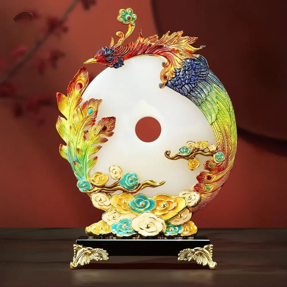 A vibrant multi-colored phoenix jade dragon phoenix ornament on a white jade-like yin-yang disc with gold accents
