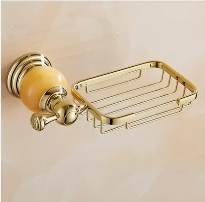 Gold-toned metal soap dish with polished ornate wall mount and amber ceramic knob from jade gold bathroom accessories set