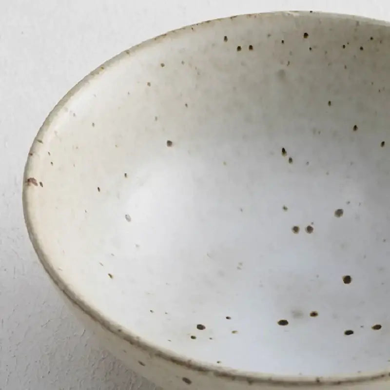 A white handmade ceramic rice bowl with speckled brown glaze for japanese beige and brown ceramic rice bowl set dining room
