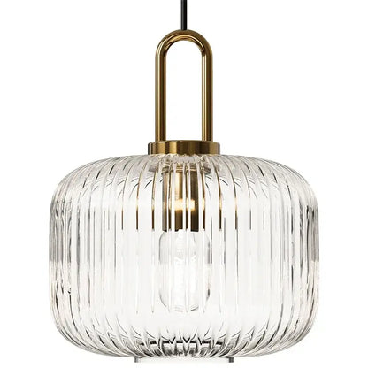 Clear ribbed glass pendant light with brass-finished metal fixture helps create elegant kitchen glass stone accents