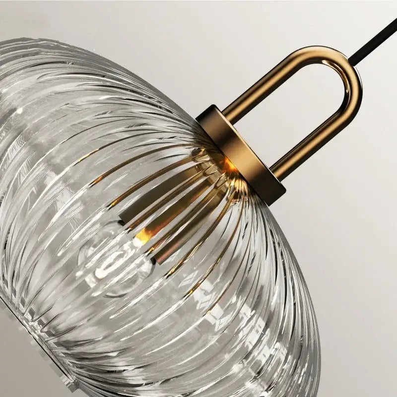Japanese clear ribbed glass pendant light with brass accents helps create a stylish kitchen glass stone fixture