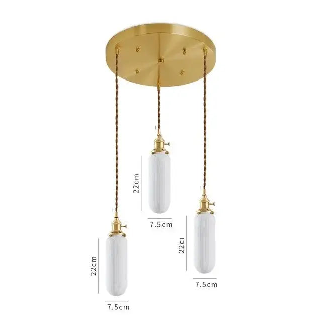 Gold-toned pendant light with three white ribbed ceramic led pendant shades suspended by twisted bronze chains for dining room decorbites ceramic led