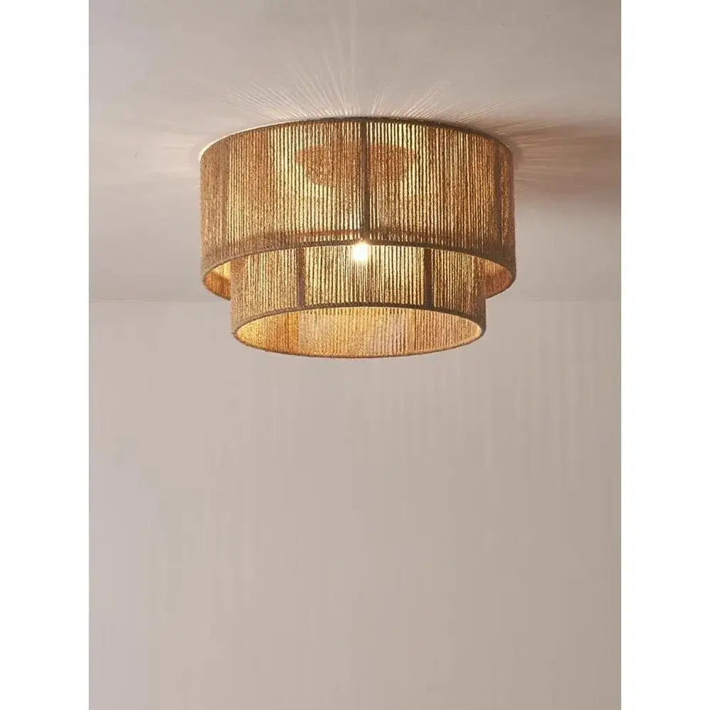 Japanese golden two tiered woven pendant light made of natural materials as a light source for dining rooms
