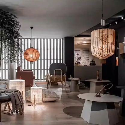 A warm-toned japanese lantern painting on peach fabric with delicate bamboo leaf patterns for dining room light