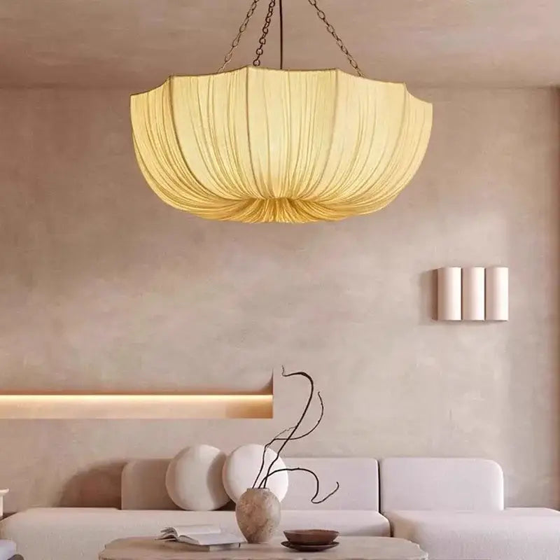 Japanese pleated white fabric pendant light with a cream shade and chain suspension, a refined choice for hospitality settings