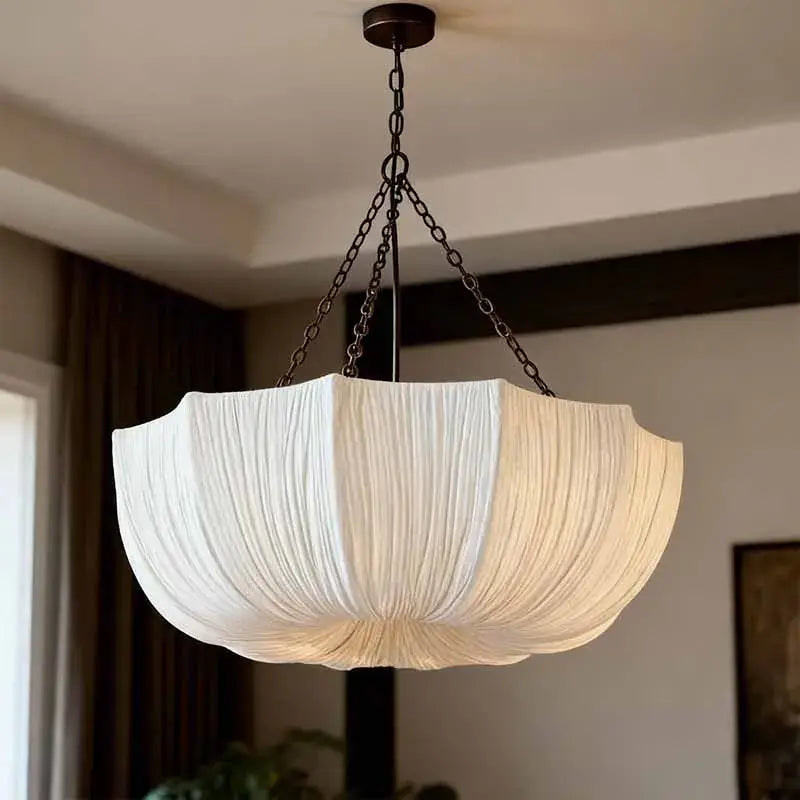 Japanese pleated white fabric pendant light with dark metal chain, a refined choice for hospitality settings
