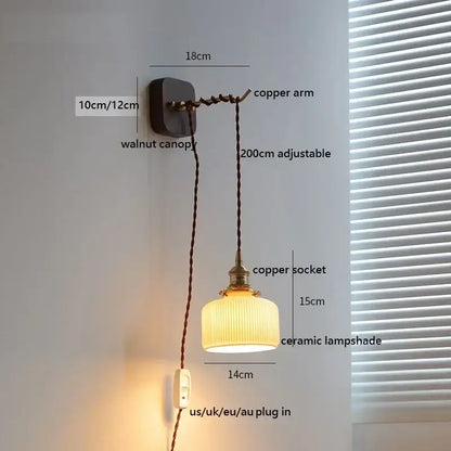 A warm-toned ceramic led wall light with vertical ridges suspended by a copper arm from a walnut canopy decorbites ceramic led