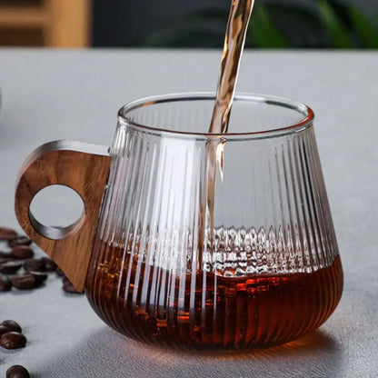 Japanese ribbed glass coffee mug with vertical ridges and wooden handle filled with dark coffee for kitchen use