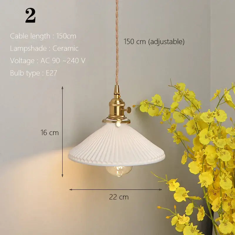 White ceramic pendant light with fluted ribbed design and brass hardware for kitchen and dining room use