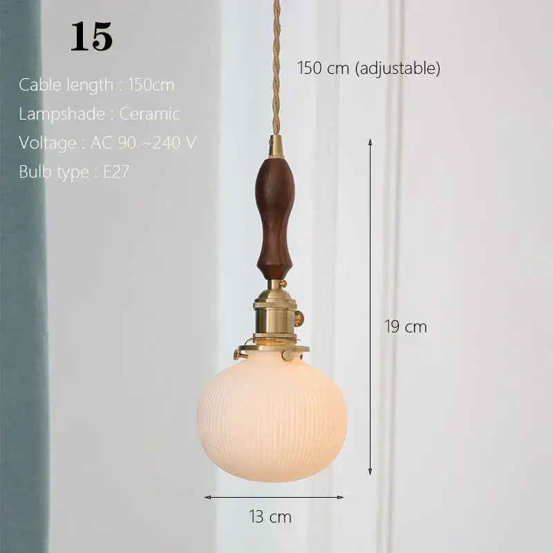 Vintage-style ceramic pendant light with white ribbed ceramic globe, brass hardware, and dark wood handle for kitchen dining room