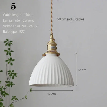 White ceramic pendant light with fluted design and brass hardware for kitchen and dining room lighting