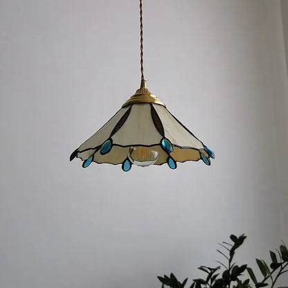 Delicate cream-colored Japanese stained glass led pendant light with turquoise accents and brass frame for kitchen island decor