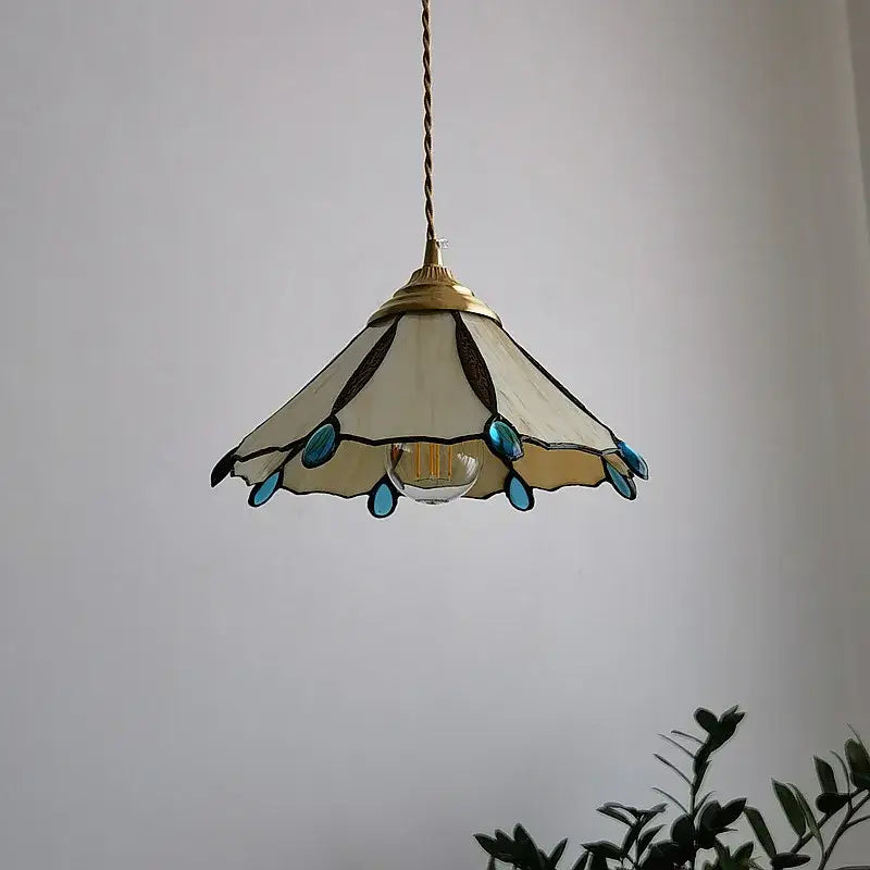 Delicate cream-colored Japanese stained glass led pendant light with turquoise accents and brass frame for kitchen island decor