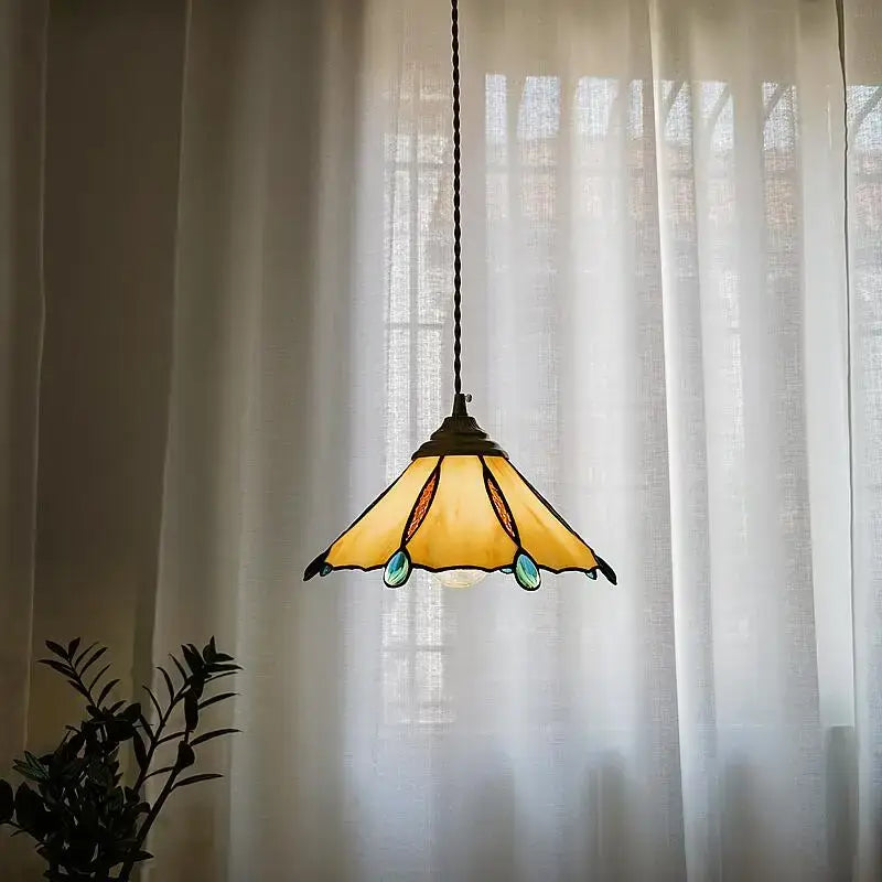 Japanese stained glass led pendant light featuring warm yellow and teal glass with dark metal frame for kitchen island decor